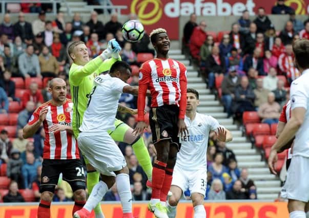 Sunderland keeper Jordan Pickford rises to deal with a cross under pressure from Jordan Ayew.