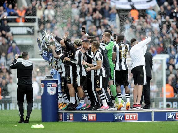 Newcastle's players celebrate winning the Championship