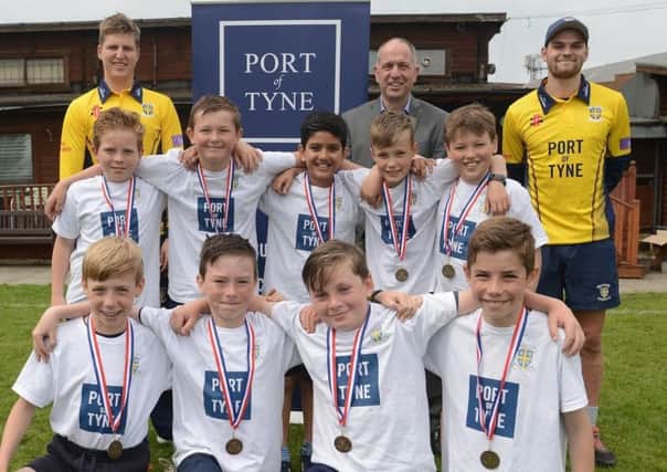 Durham cricketers Brydon Carse and Jack Burnham with young cricketers and   Port of Tyne chief operating officer Stephen Harrison.