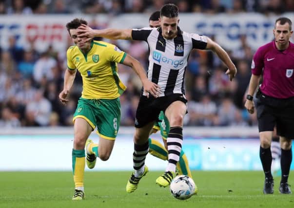 Newcastle Uniteds Ciaran Clark (right) and Norwich Citys Jonny Howson battle for the ball.