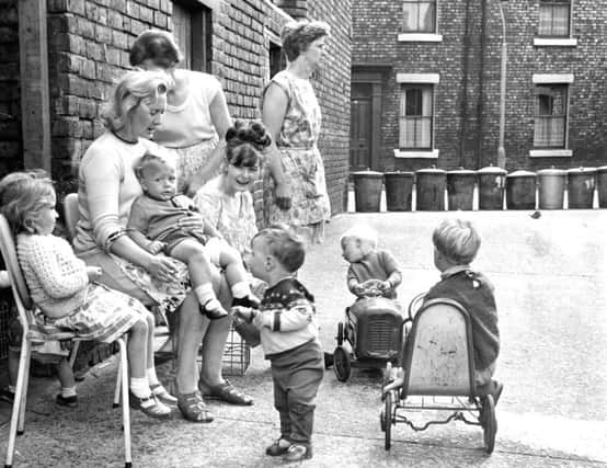 Mams and little ones in Byethorne Street, South Shields. Why the dustbin barricade?