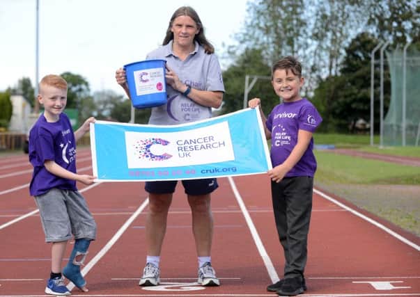 Relay for Life organiser Ann Walsh with survivors Charlie Mordey, 8 and Harrison Cochrane, 8 (R)