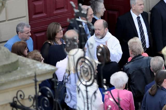 Father Chris Fuller talking to mourners before the Liam Curry and Chloe Rutherford funeral service.