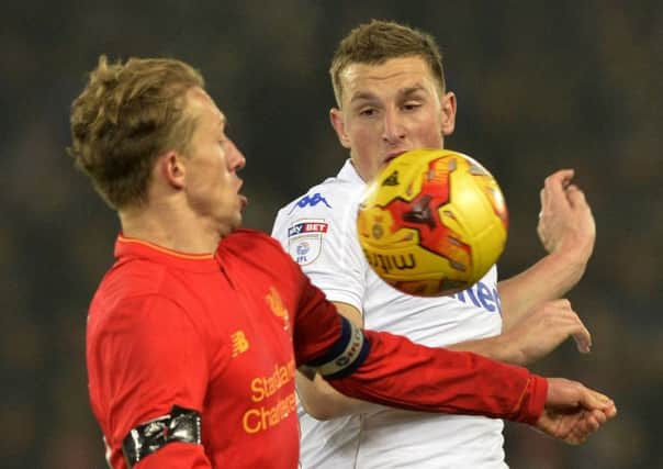 Liverpool midfielder Lucas Leiva battles against Leeds striker Chris Wood (right).