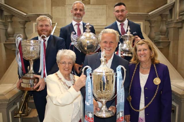 Back row from left, South Shields FC joint managers Graham Fenton and Lee Picton, with goalkeeper Liam Connell, and front row from left, Mayoress Mary French, South Shields FC chairman Geoff Thompson and the Mayor of South Tyneside, Coun Olive Punchion, with the four trophies won by the Mariners this season. Image by Peter Talbot.