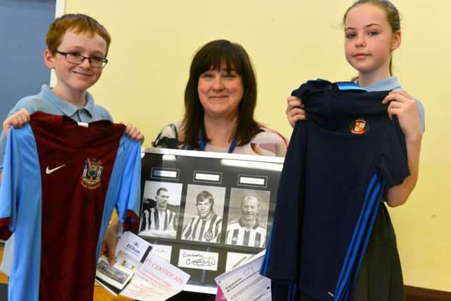 SS Peter and Paul RC Primary School are to hold a raffle in memory of Liam Curry. Head boy Logan Kilburn, 11 and head girl Brooke Elliott, 10 with headteacher Maria Butt