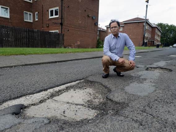 Resident Ali Hayder near a pothole in Bedford Avenue, Laygate, South Shields.
