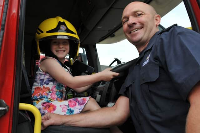 Isabelle Clegg in the driving seat with fireman Troy Curry at South Shields Community Fire Station open day.