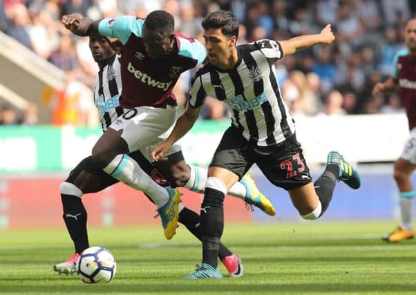 Newcastle Uniteds Merino and West Ham Uniteds Michail Antonio battle for the ball.