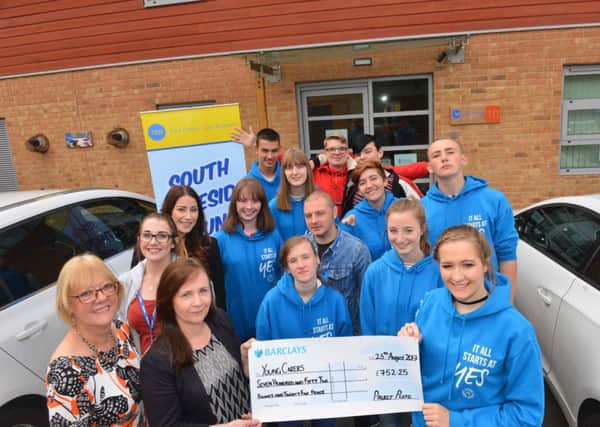 NCS volunteers hand over funds to Young Carers Association's Karen Ahmed