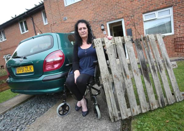 Catherine Mitchell, of Jarrow, with the pallet she had hurled at her window and car. Picture: TOM BANKS