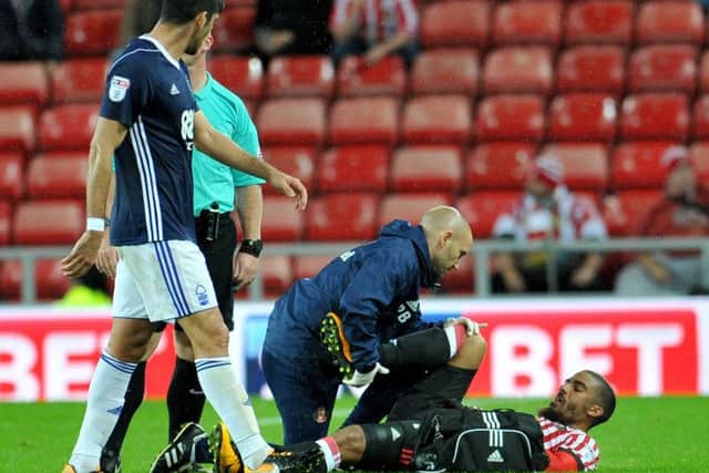 Lewis Grabban lies injured against Forest