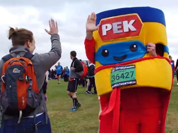 PEK Man celebrates crossing the Great North Run finish line.