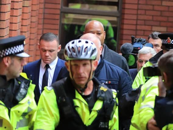 Wayne Rooney, second left, outside Stockport Magistrates' Court on Monday morning.