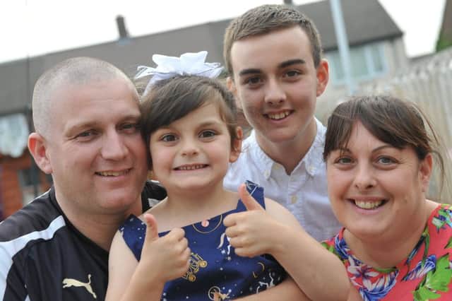Kayleigh Brennan is now in remission, with parents Rob and Lindsay, brother Daniel.