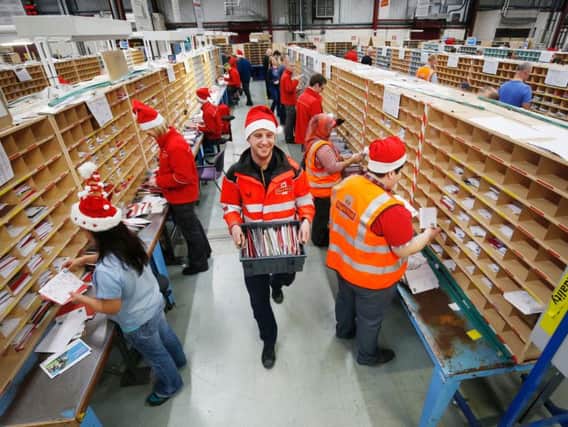 Employees at a Royal Mail centre wearing Santa hats in the run up to a previous festive period. Picture by Danny Lawson/PA Wire