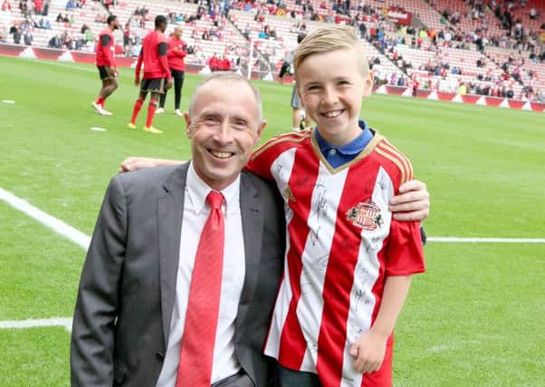 Foundation fundraiser Roy Hammonds with his grandson Aaron at the Stadium of Light.