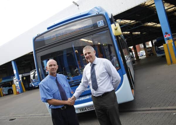 Stagecoach North East driver Brian Usher with the company's operations director Colin Newbury.