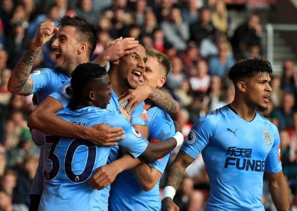 Newcastle United's Isaac Hayden celebrates scoring with team-mates.