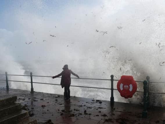 Wind and waves blast the coast at Penzance, Cornwall, during Storm Ophelia.