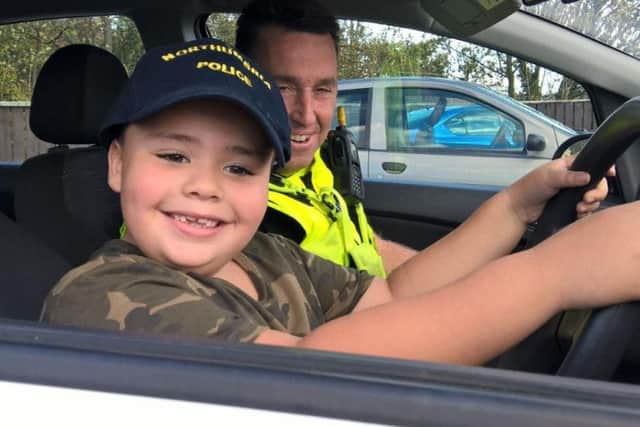 Ellis Hardy was thrilled to sit in the driving seat of a marked police car.