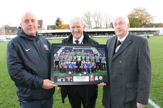 Stafford Rangers representatives present a picture in honour of Jak Fada to South Shields FC vice-chairman Gary Crutwell, left. Pic: Peter Talbot.