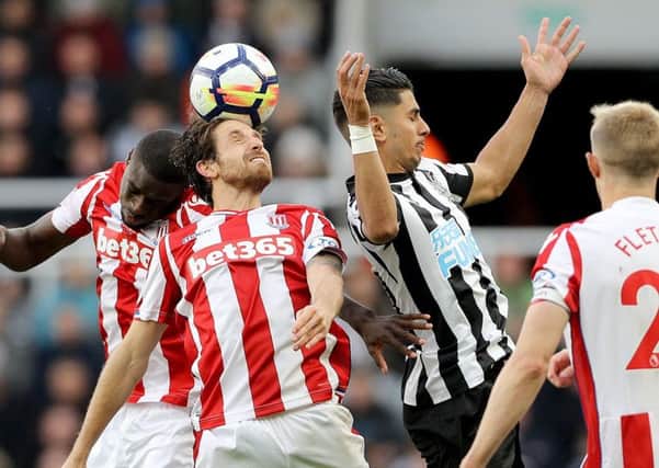Newcastle United's Ayoze Perezis beaten to the ball by Stoke City's Joe Allen.