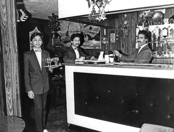 Farouk Hussein serves drinks from the new cocktail bar at the Shanti Tandoori in December 1984.