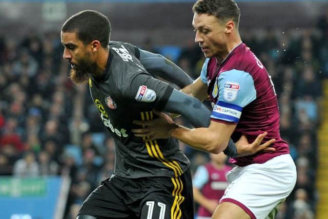 Sunderland's Lewis Grabban battles to keep Villa defender James Chester at bay. Picture by Frank Reid