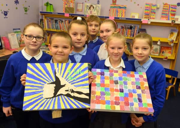 Pupils show off their work at the art exhibition.