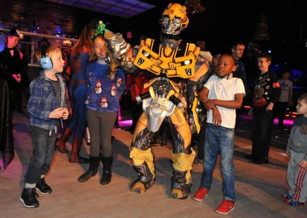 Youngsters meet a Transformer at the Hope4kidz Christmas party.