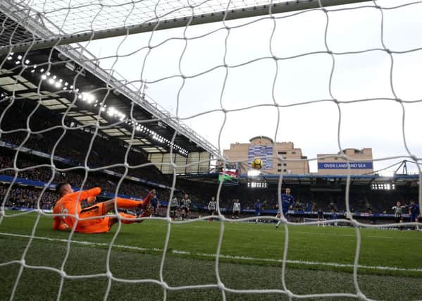 Chelseas Eden Hazard scores his sides third goal from the penalty spot deceiving Karl Darlow in the Newcastle United goal.