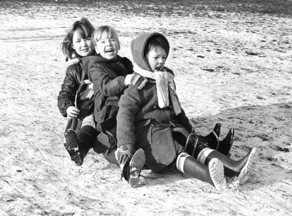 Cousins Gary Cavanagh, 6, Victoria Cavanagh, 7, and Lora Cavanagh, 8, sledging at Robin Hood Bank, Primrose, Jarrow.