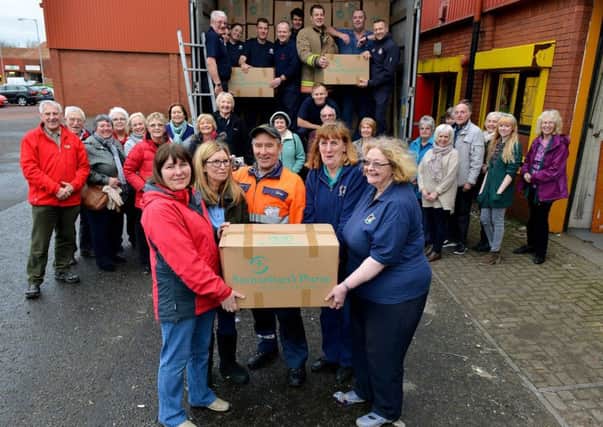 Carol Hall (front right) with volunteers as they load the lorry with boxes. Picture by FRANK REID