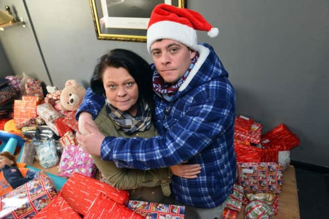 Jak's dad, Tony Fada, with grandmother Julie Bright with some of the presents.