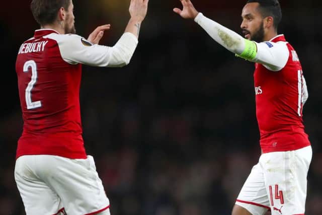 Mathieu Debuchy and Theo Walcott, right