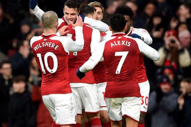 Arsenal's Mesut Ozil (centre) celebrates his winner.