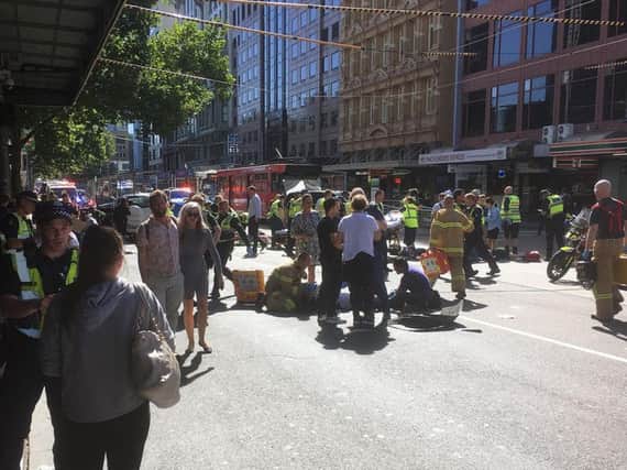 Paramedics treat a victim after a car ploughed into pedestrians in Melbourne, Australia. Picture: Andrew Lund/Twitter.
