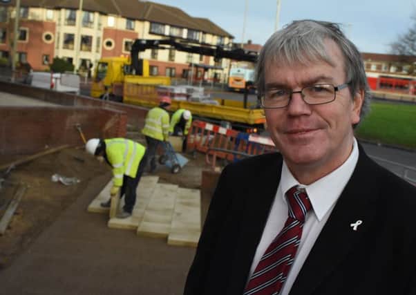 Councillor Neil Maxwell, Harton ward member, oversees some of the latest footpath renewal work taking place on the Harton side of Horsley Hill Square.