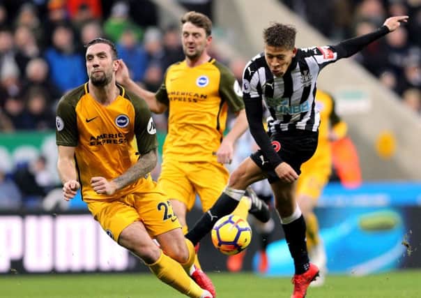 Newcastle United's Dwight Gayle and Brighton & Hove Albion's Shane Duffy (left) battle for the ball.