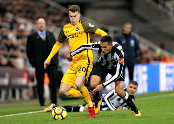 Newcastle United's Isaac Hayden battle for the ball with Brighton & Hove Albion's Solly March.