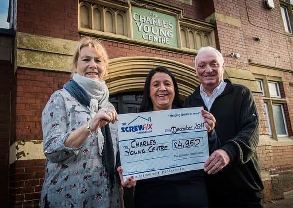 South Shields Screwfix manager Denise Smith presents cheque to help with the roof repairs to Gordon Robertshaw and Elsa Larsen of the Charles Young Centre. Michael Baister Photography