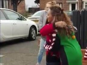 Jade hugs her shocked mum Norma after presenting her with the generous gift.