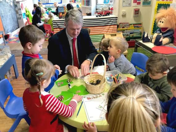 Huw Irranca-Davies Minister for Children and Social Care in Wales with a group of children.