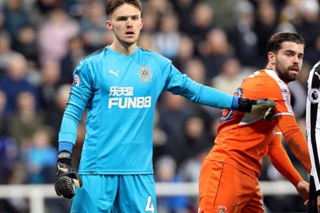 Newcastle United goalkeeper Freddie Woodman (left) and Luton Town's Elliot Lee during the FA Cup, third round match at St James's Park.