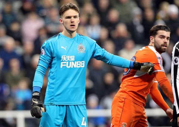 Newcastle United goalkeeper Freddie Woodman (left) and Luton Town's Elliot Lee during the FA Cup, third round match at St James's Park.
