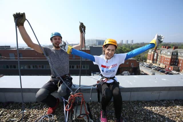 Phoebe Hedley with abseil instructor Ben Ritchie before she walked down the side of the RVI in Newcastle in 2016.