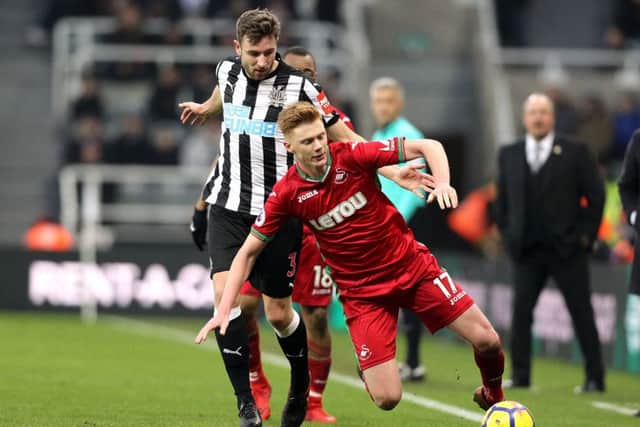 Paul Dummett and Swansea City's Sam Clucas battle for the ball