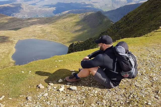 Rhys Iles at a peak during a previous walk in the Lake District,
