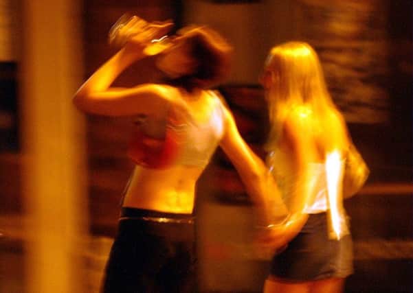 Girls drinking in the street.